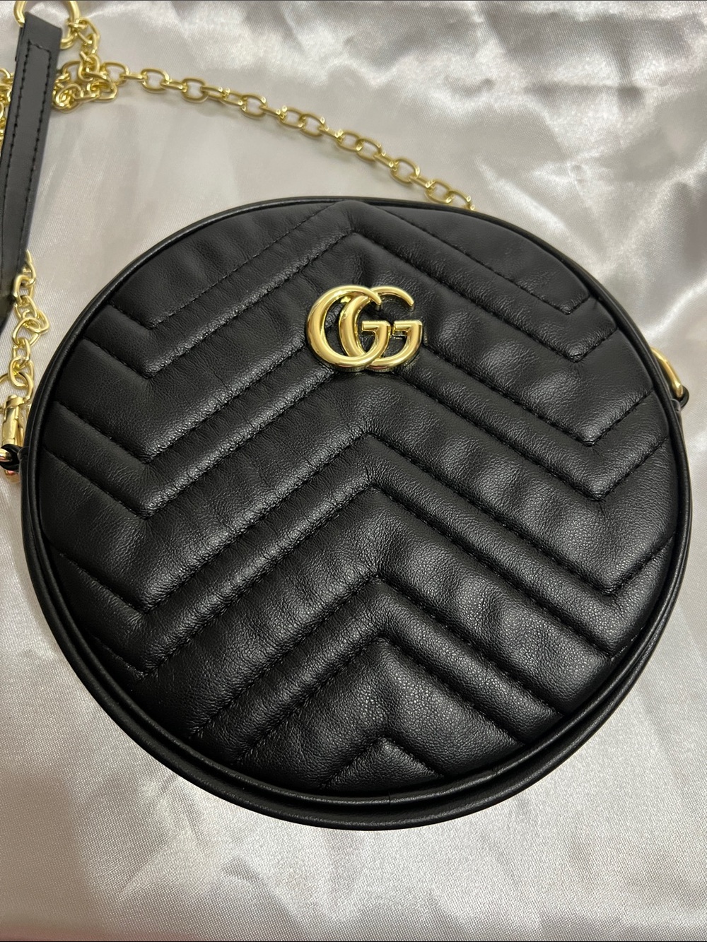 Black Quilted Round Crossbody Bag with Gold Logo Accent